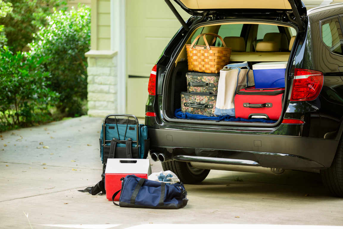 Family vehicle packed, ready for road trip, vacation outside home.